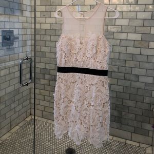 White lace dress with black detail.